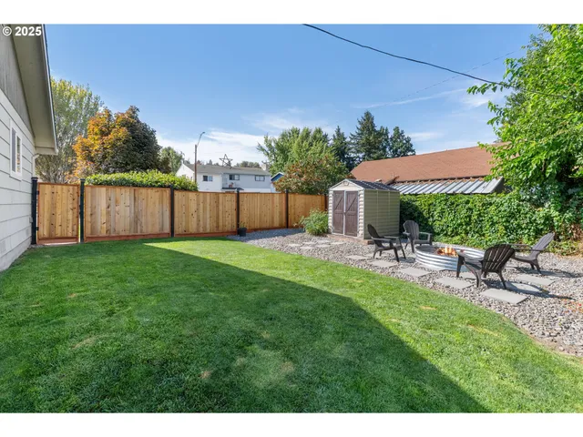 a view of backyard with a garden and outdoor seating