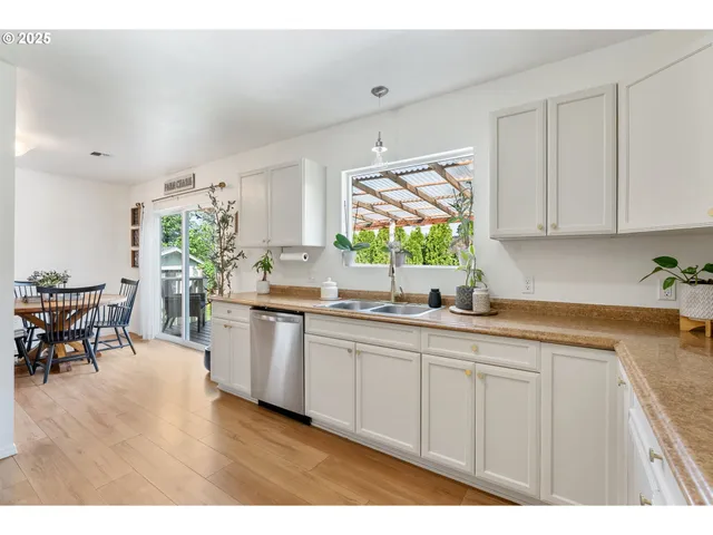 a kitchen with stainless steel appliances granite countertop a sink and cabinets