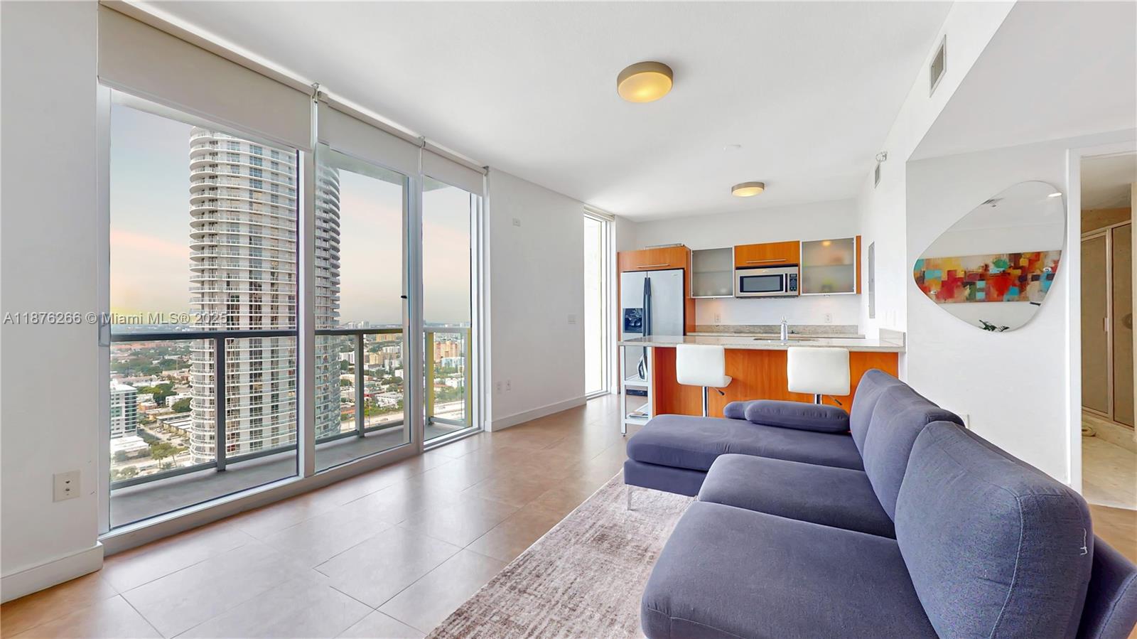 185 Southwest 7th Street, Unit 2900 Miami, FL 33130 - Photo 11 of 25 a living room with furniture and a floor to ceiling window
