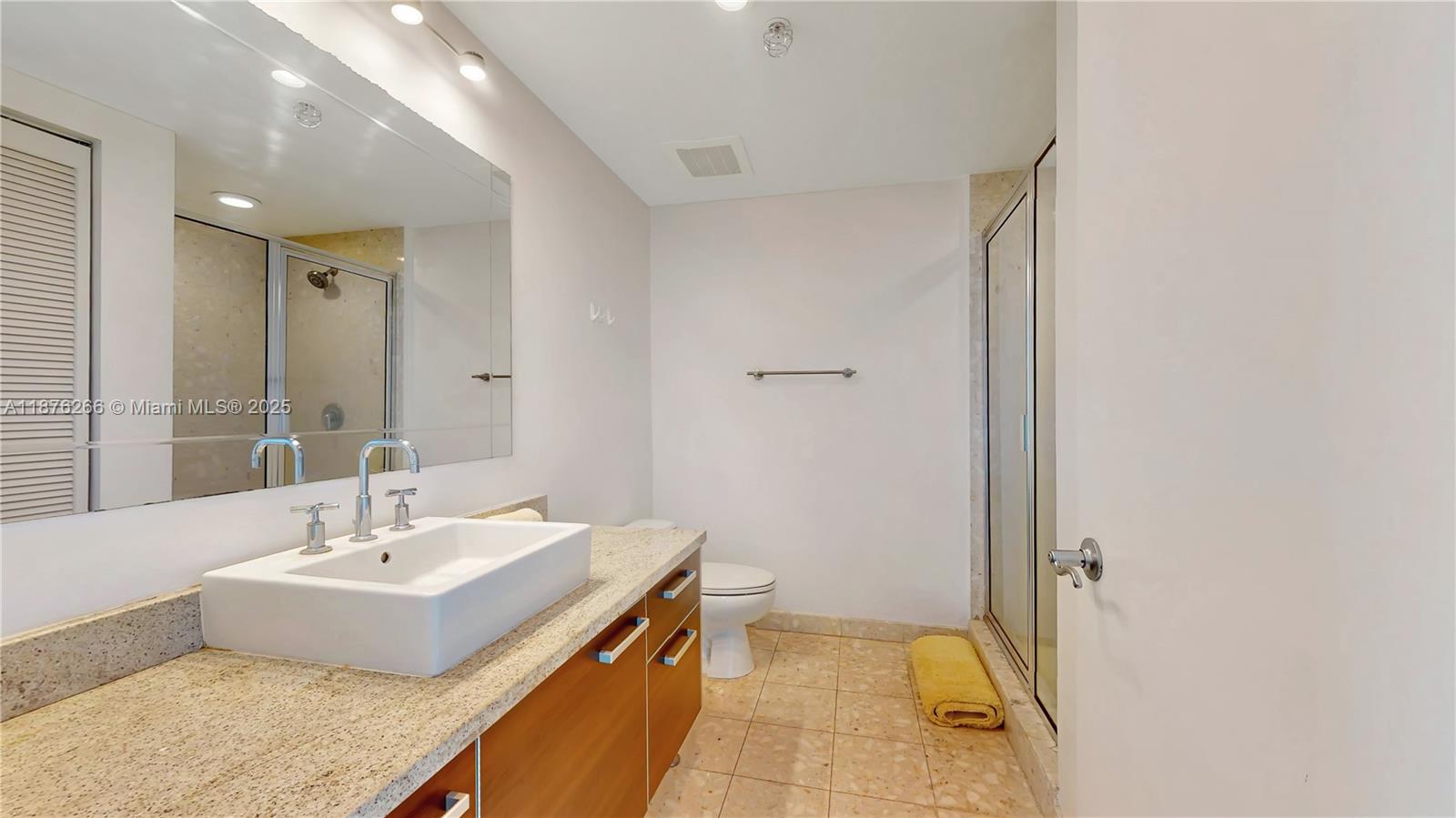 185 Southwest 7th Street, Unit 2900 Miami, FL 33130 - Photo 13 of 25 a bathroom with a sink and a mirror