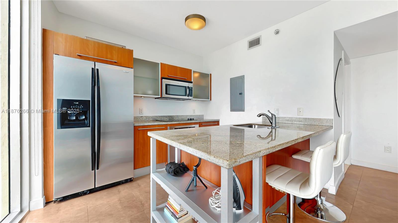 185 Southwest 7th Street, Unit 2900 Miami, FL 33130 - Photo 6 of 25 a kitchen with stainless steel appliances granite countertop a sink and a refrigerator