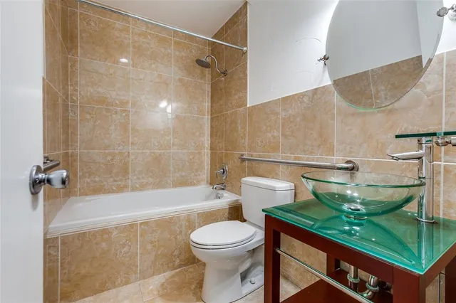 a bathroom with a sink a toilet and bathtub
