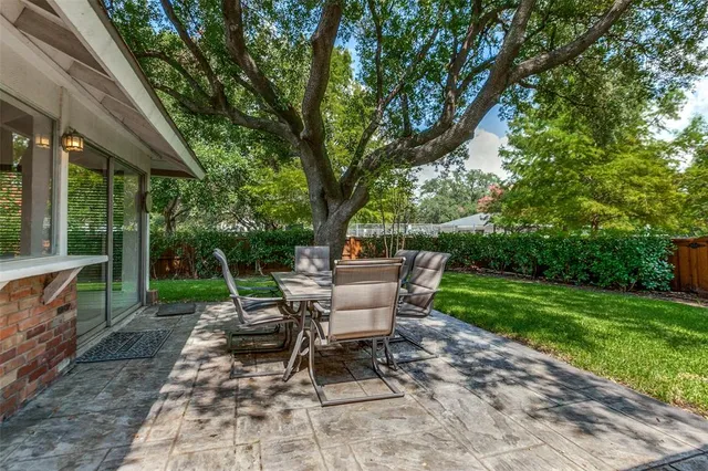 a view of a chair and tables in the backyard