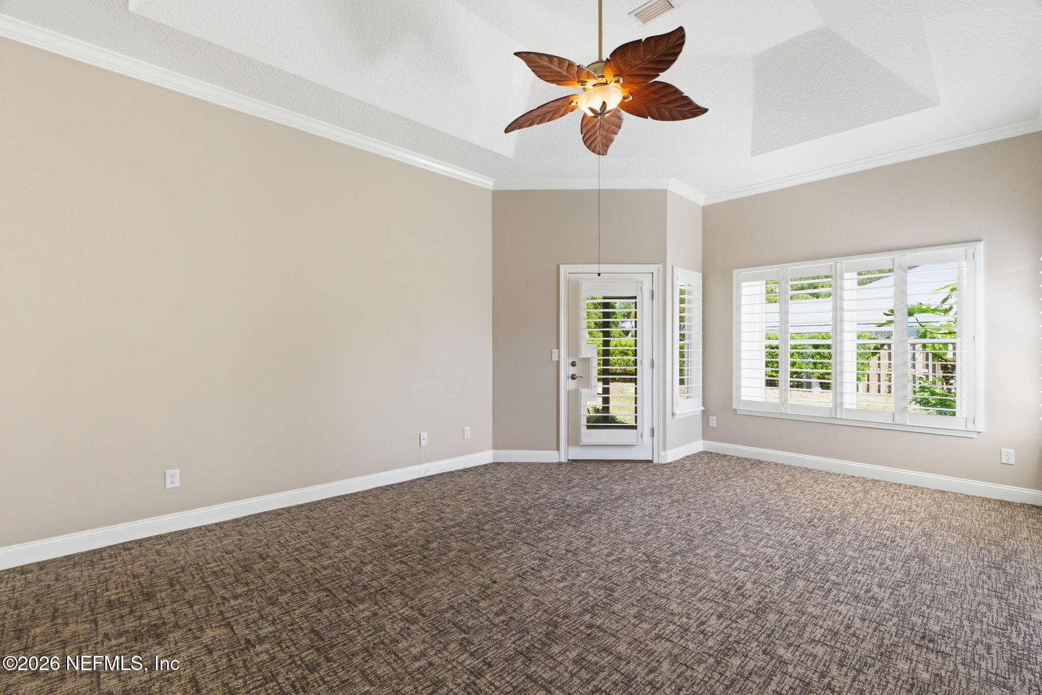 1600 Spring Water Court Fleming Island, FL 32003 - Photo 49 of 85 an empty room with windows and a ceiling fan