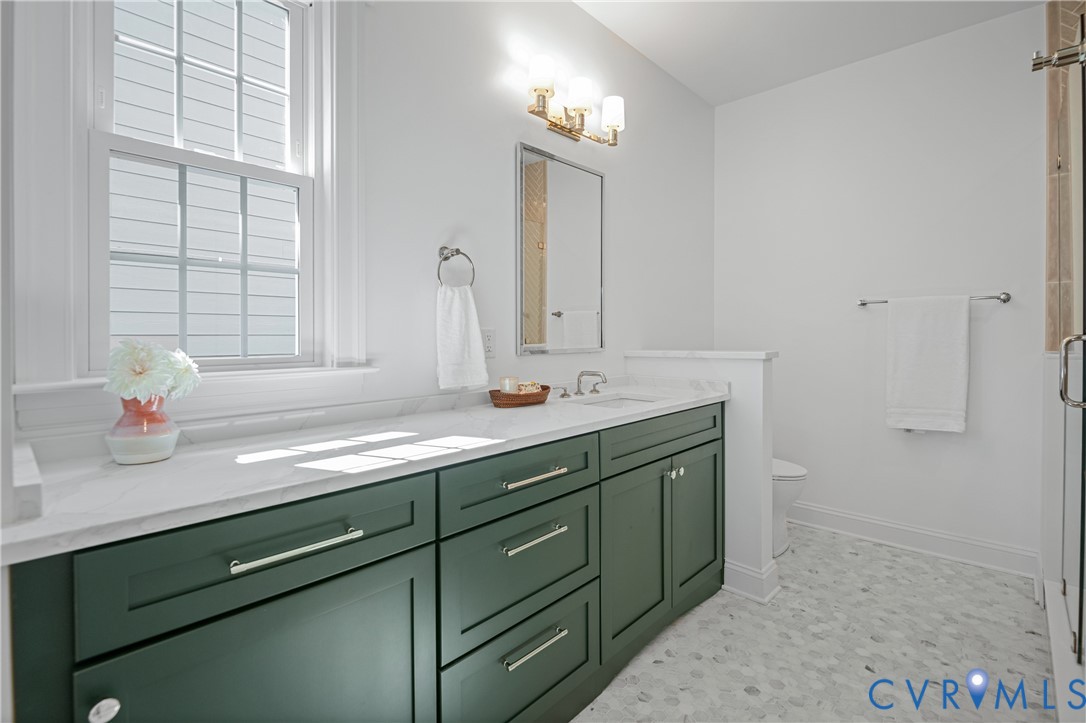 4705 Fitzhugh Avenue Richmond, VA 23230 - Photo 25 of 50 a bathroom with a sink and a mirror