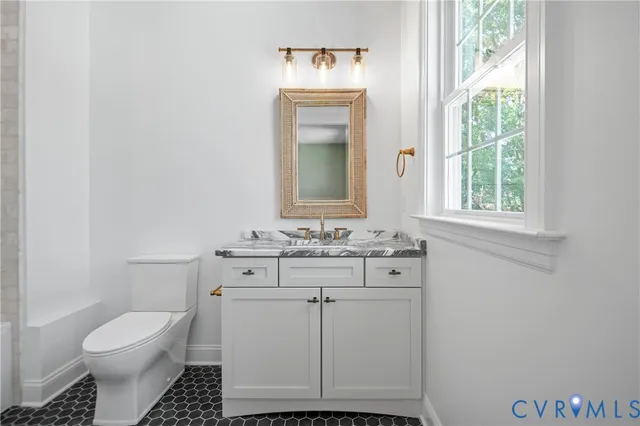 a bathroom with a toilet sink and mirror