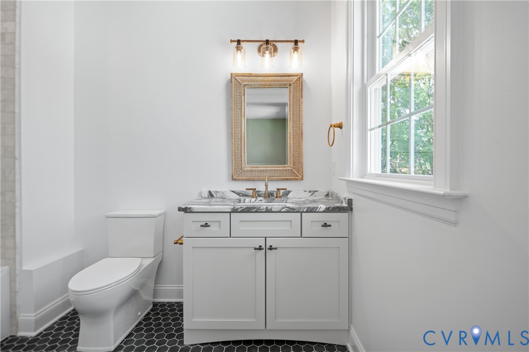 4705 Fitzhugh Avenue Richmond, VA 23230 - Photo 31 of 50 a bathroom with a toilet sink and mirror
