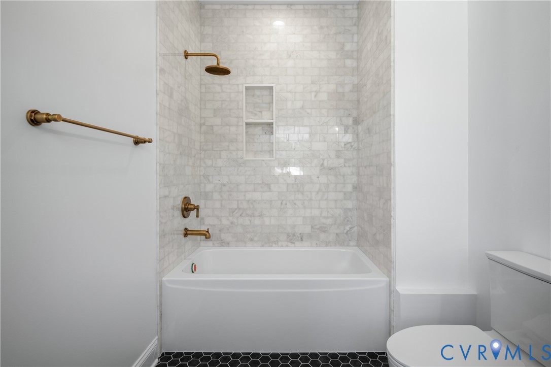 4705 Fitzhugh Avenue Richmond, VA 23230 - Photo 32 of 50 a bathroom with a toilet and a bath tub