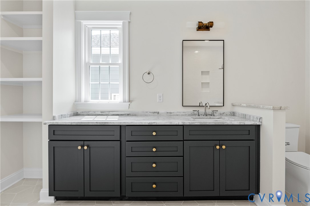 4705 Fitzhugh Avenue Richmond, VA 23230 - Photo 36 of 50 a bathroom with a granite countertop sink and a mirror
