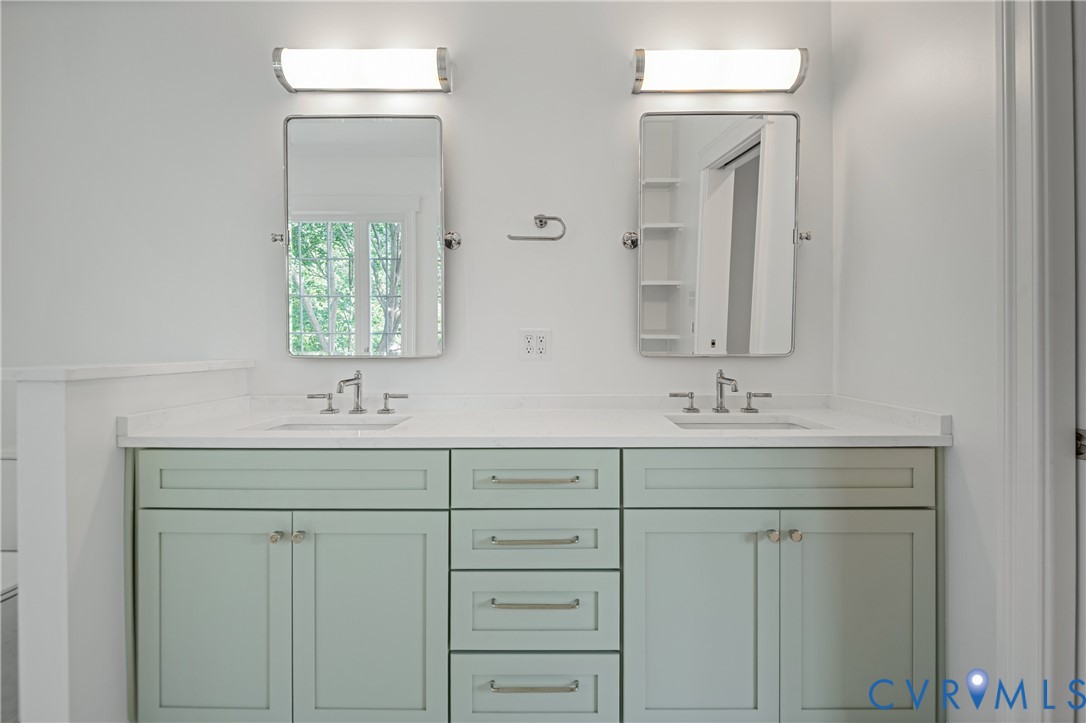 4705 Fitzhugh Avenue Richmond, VA 23230 - Photo 40 of 50 a bathroom with a sink and a mirror
