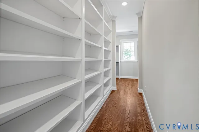a view of walk in closet with empty racks