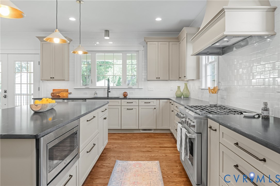4705 Fitzhugh Avenue Richmond, VA 23230 - Photo 10 of 50 a kitchen with stainless steel appliances granite countertop a sink stove and cabinets