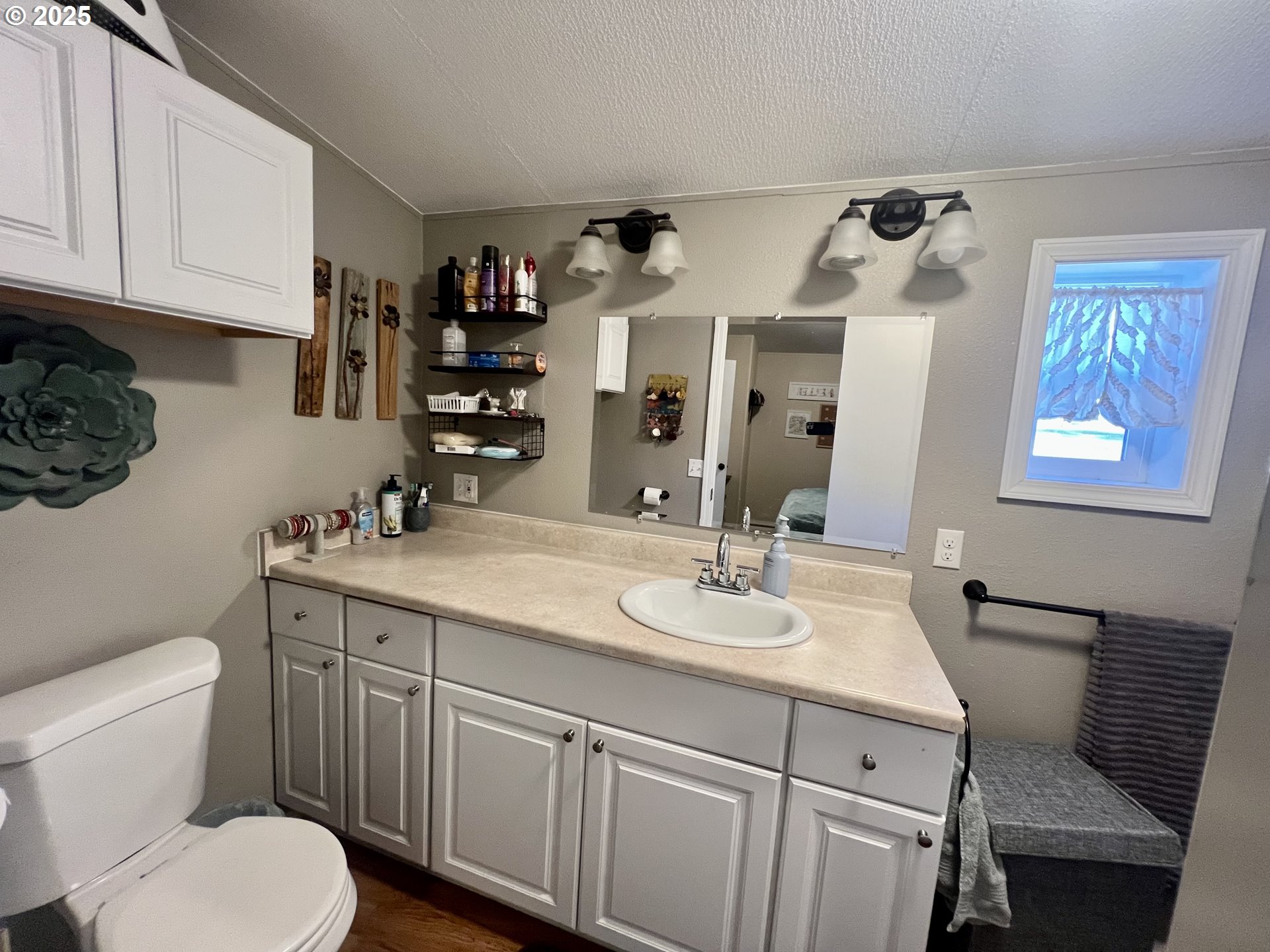 548 Pioneer Court Union, OR 97883 - Photo 10 of 18 a bathroom with a toilet a sink and mirror