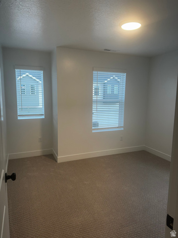 15 South Lunar Way Mapleton, UT 84664 - Photo 12 of 13 Empty room with dark colored carpet and a textured ceiling