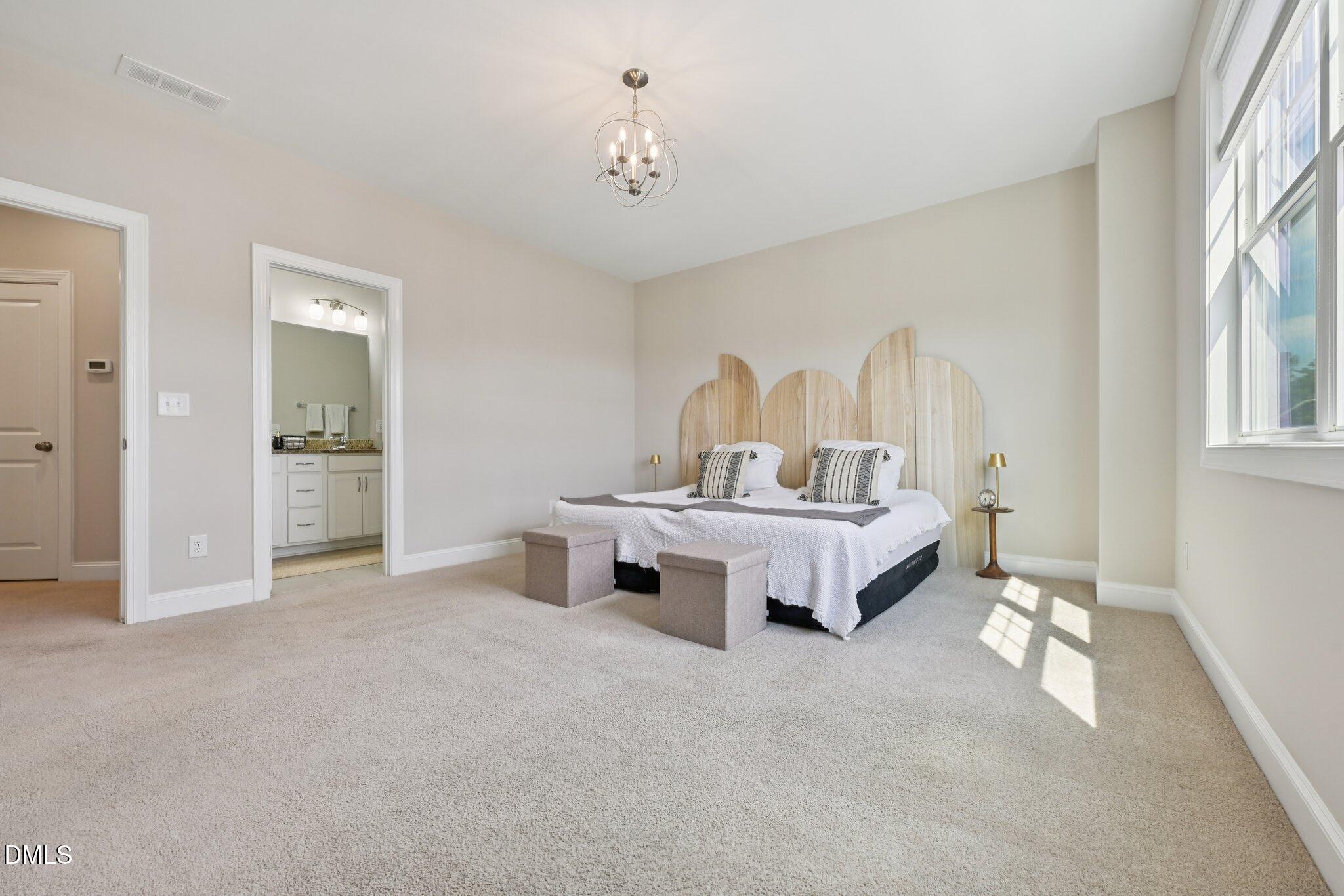 8405 Zinc Autumn Path Raleigh, NC 27615 - Photo 11 of 24 a spacious bedroom with a bed and a window