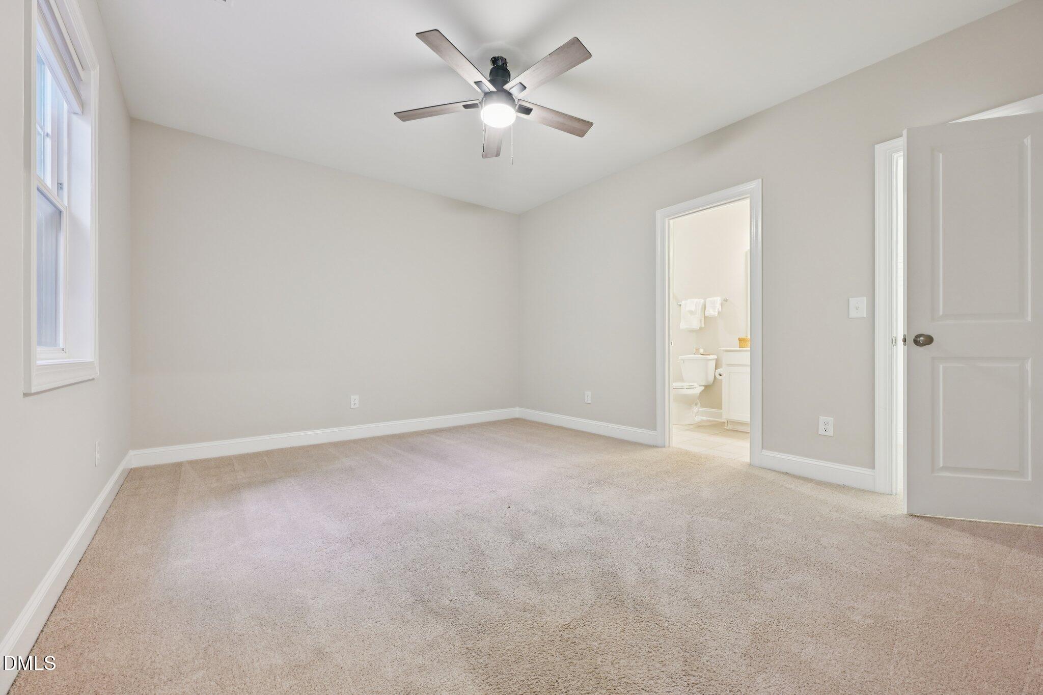 8405 Zinc Autumn Path Raleigh, NC 27615 - Photo 14 of 24 an empty room with a ceiling fan and a window