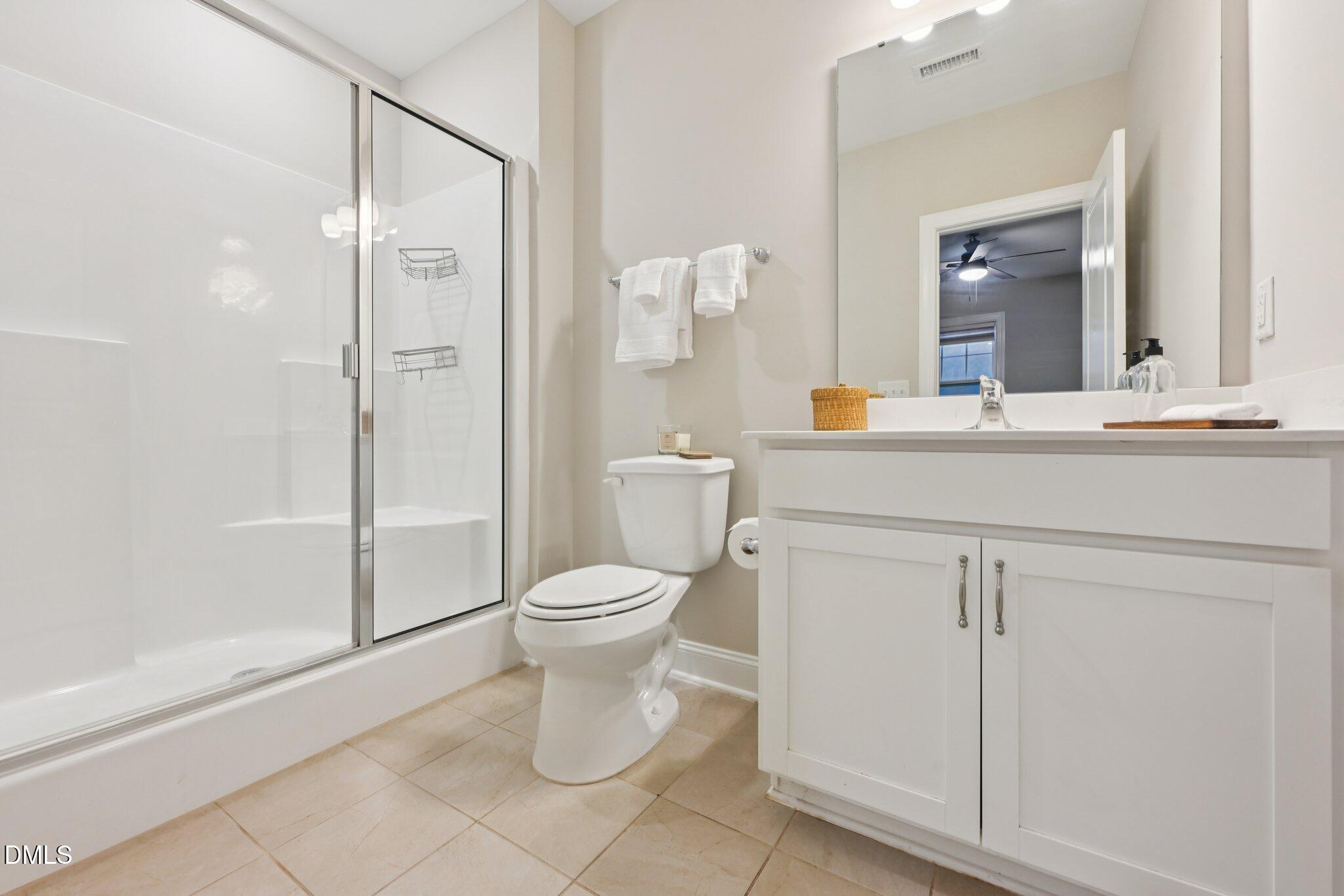 8405 Zinc Autumn Path Raleigh, NC 27615 - Photo 16 of 24 a bathroom with a toilet sink and shower