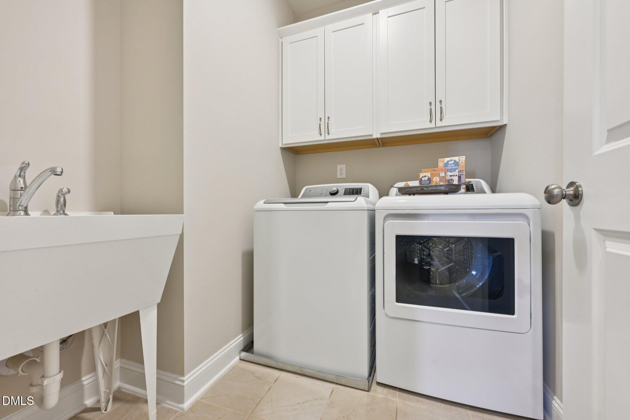 8405 Zinc Autumn Path Raleigh, NC 27615 - Photo 17 of 24 a utility room with dryer and washer