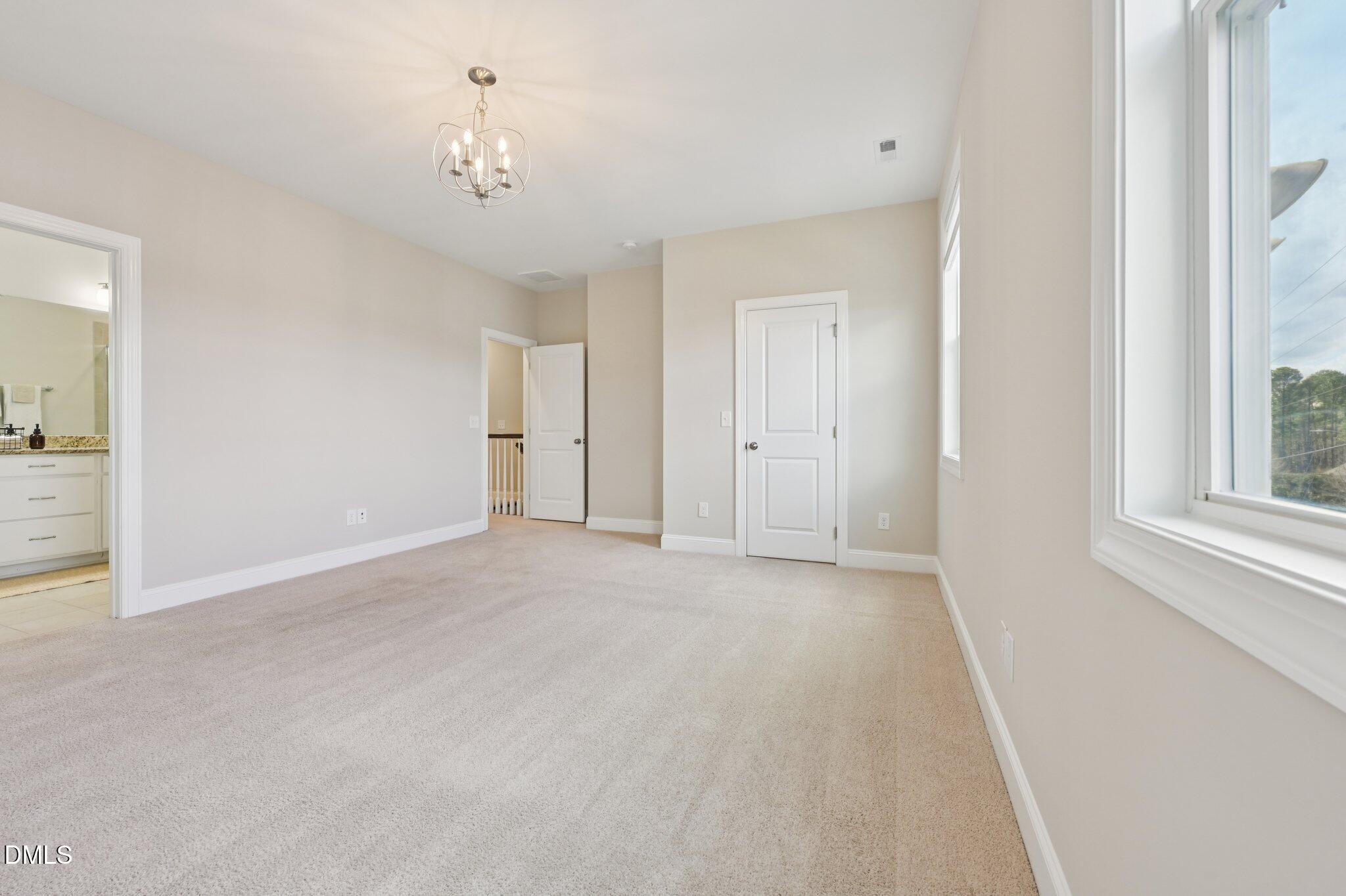 8405 Zinc Autumn Path Raleigh, NC 27615 - Photo 20 of 24 a view of a chandelier fan and entryway