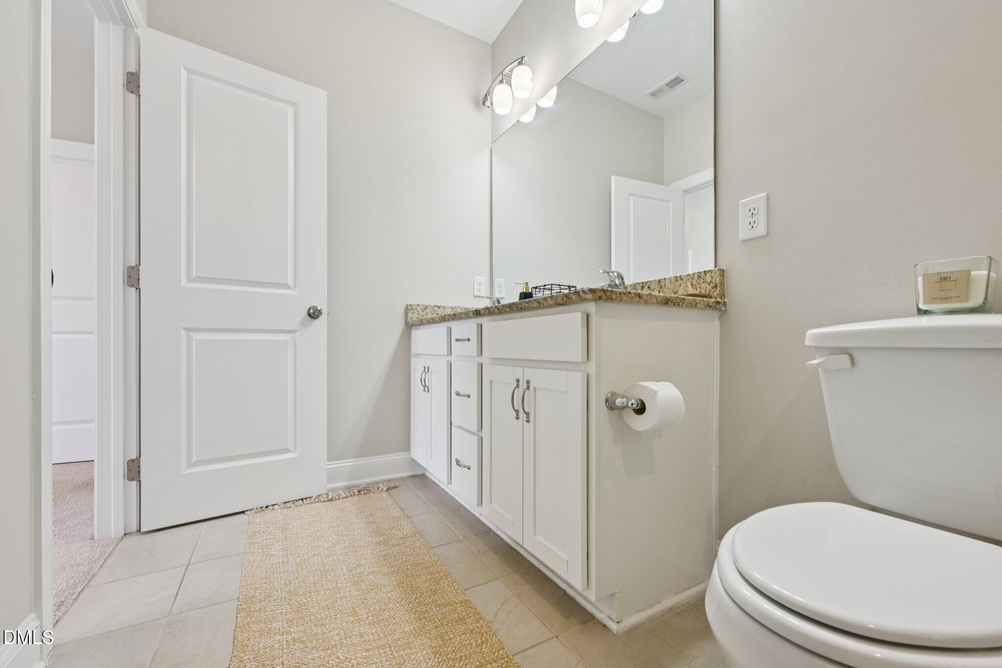 8405 Zinc Autumn Path Raleigh, NC 27615 - Photo 21 of 24 a bathroom with a toilet a sink and a shower
