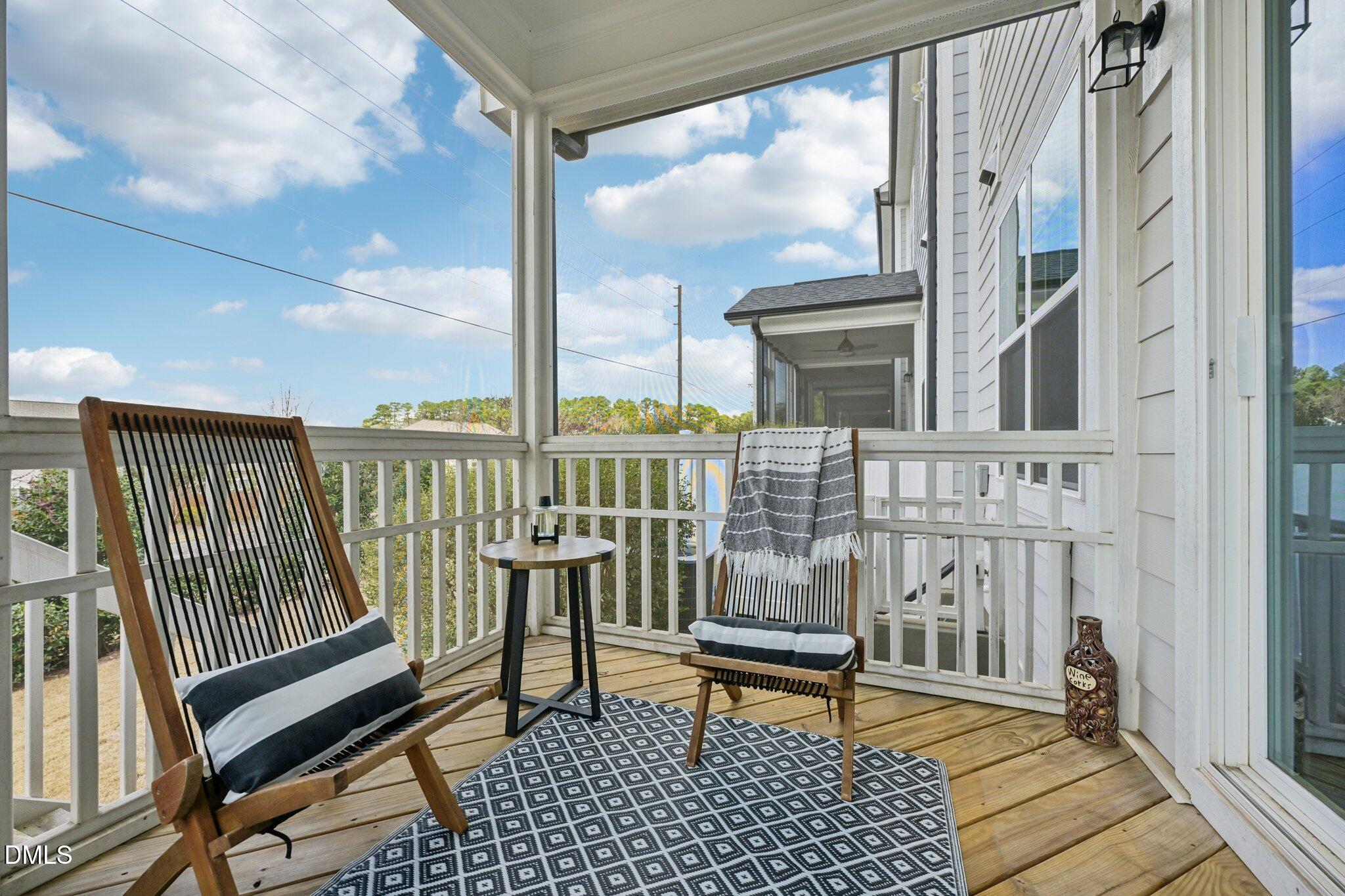 8405 Zinc Autumn Path Raleigh, NC 27615 - Photo 22 of 24 a view of a balcony with wooden chairs and table
