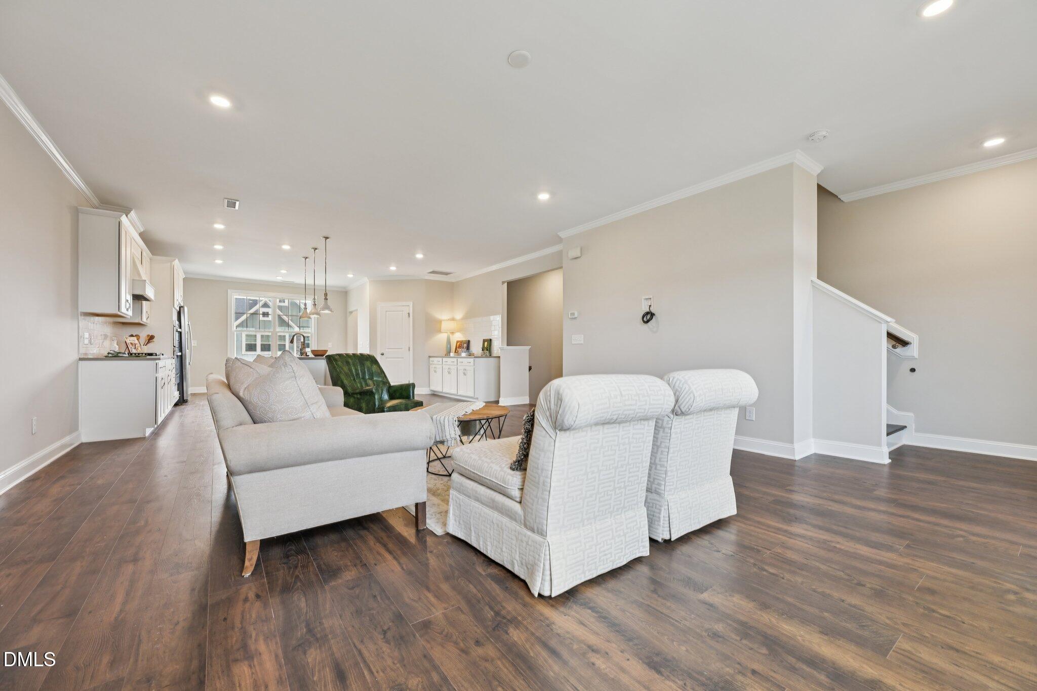 8405 Zinc Autumn Path Raleigh, NC 27615 - Photo 4 of 24 a living room with furniture and a wooden floor