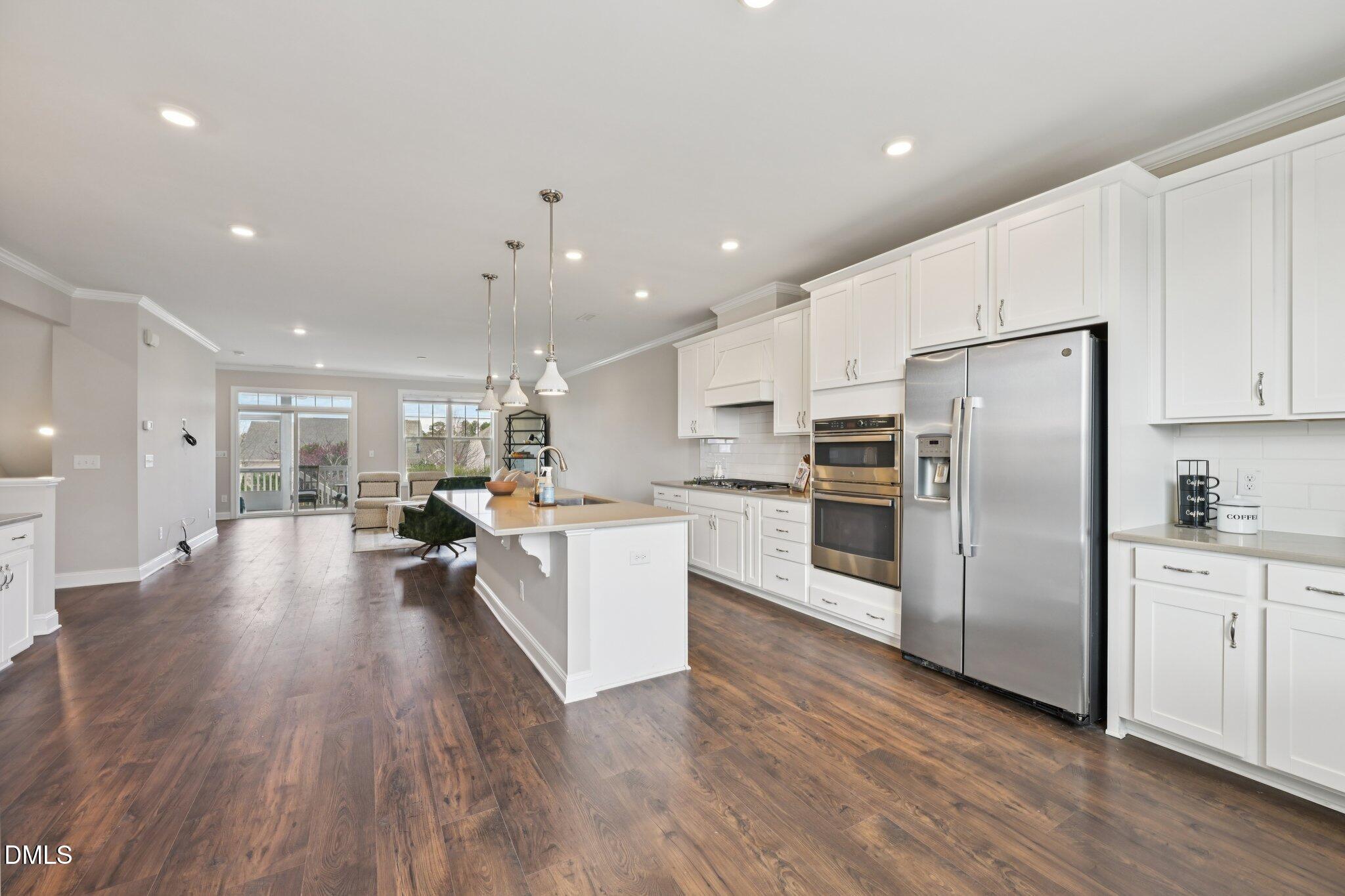 8405 Zinc Autumn Path Raleigh, NC 27615 - Photo 7 of 24 a kitchen with a refrigerator and a sink