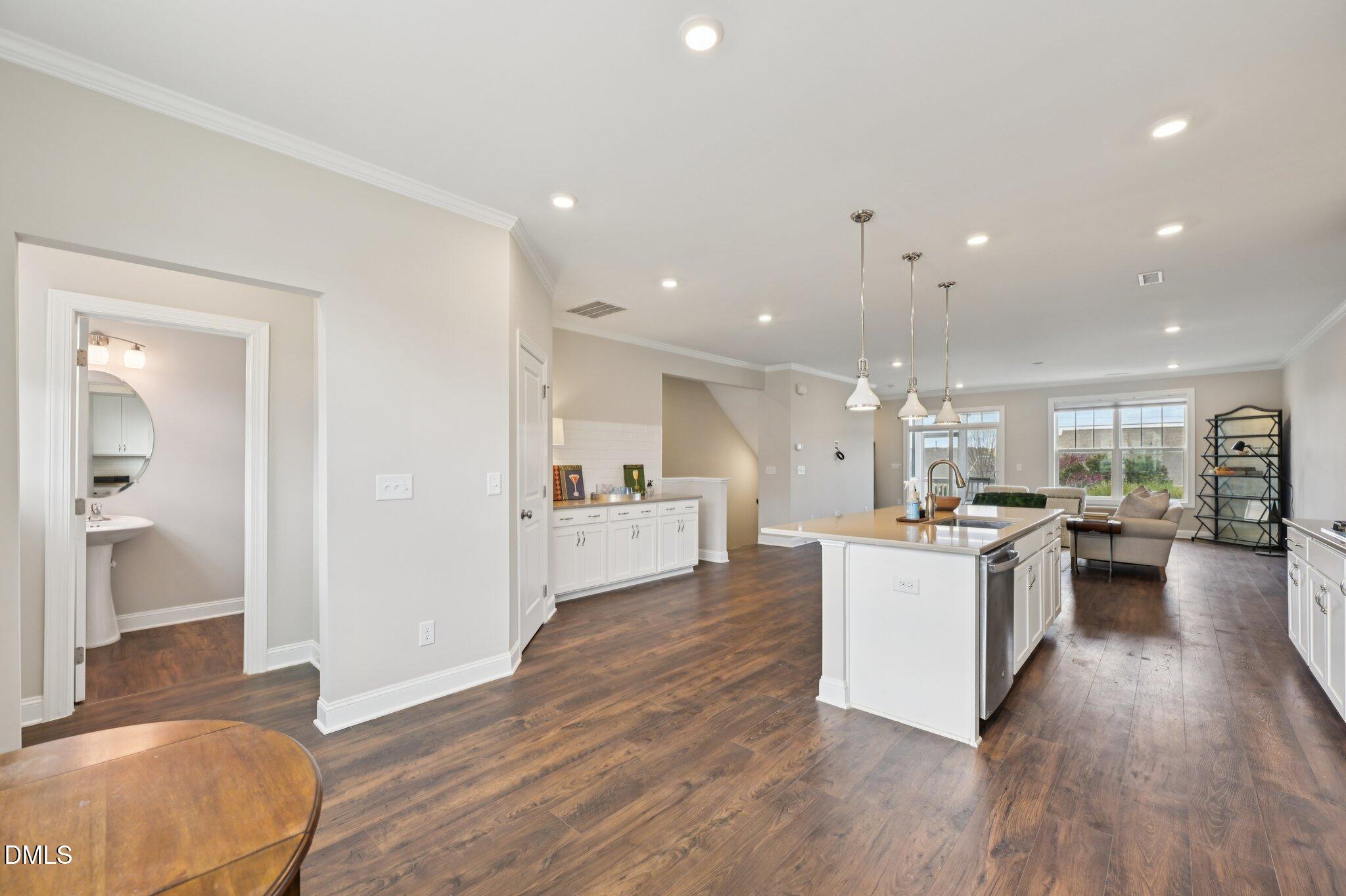 8405 Zinc Autumn Path Raleigh, NC 27615 - Photo 8 of 24 a kitchen with a sink and wooden floor