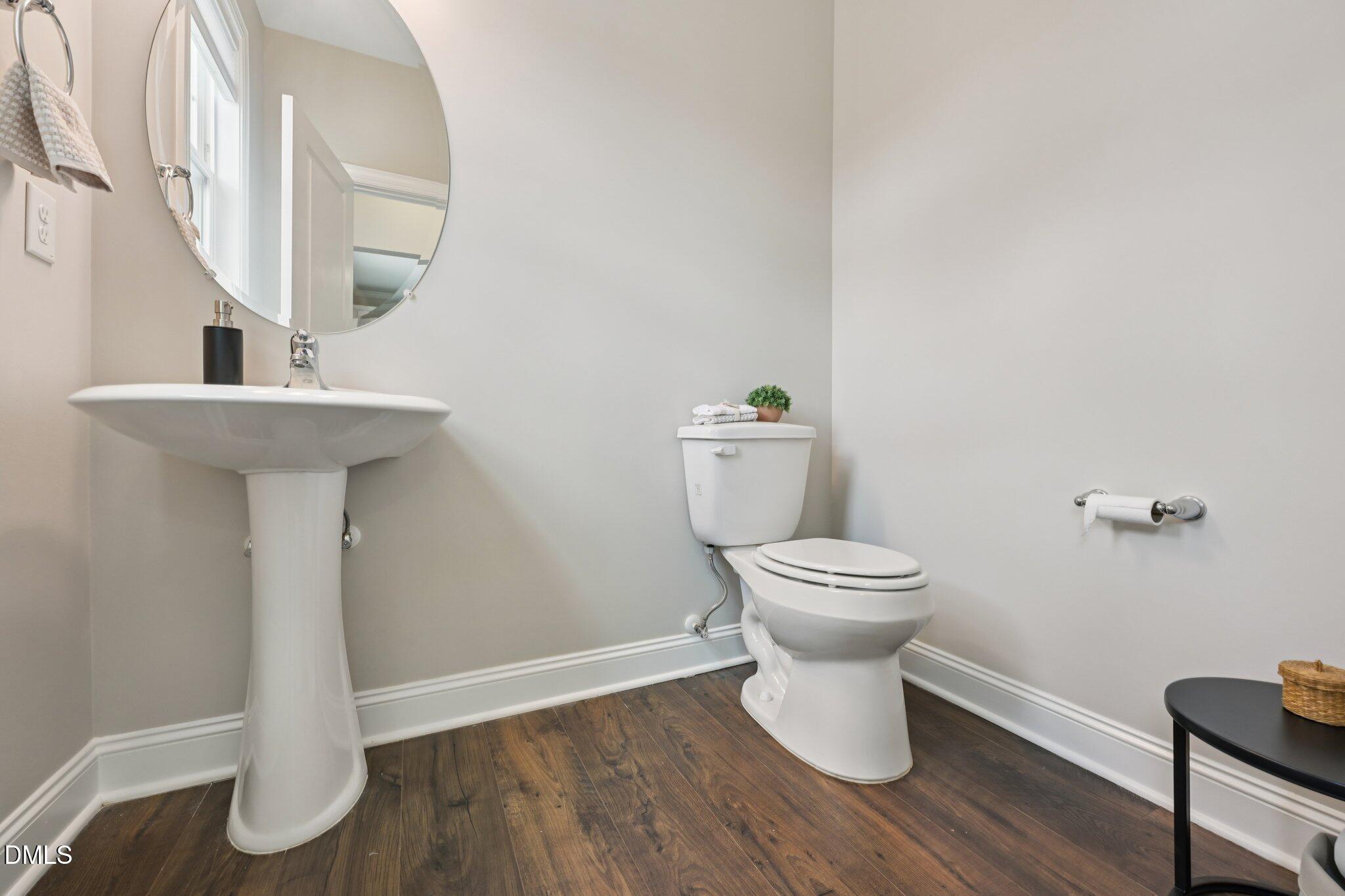 8405 Zinc Autumn Path Raleigh, NC 27615 - Photo 9 of 24 a bathroom with a toilet and a sink