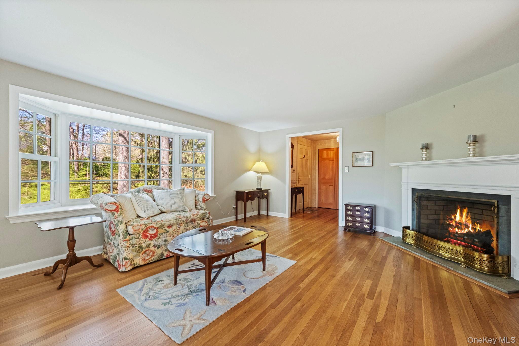 12 Harris Road Katonah, NY 10536 - Photo 11 of 38 a living room with furniture a fireplace and a table