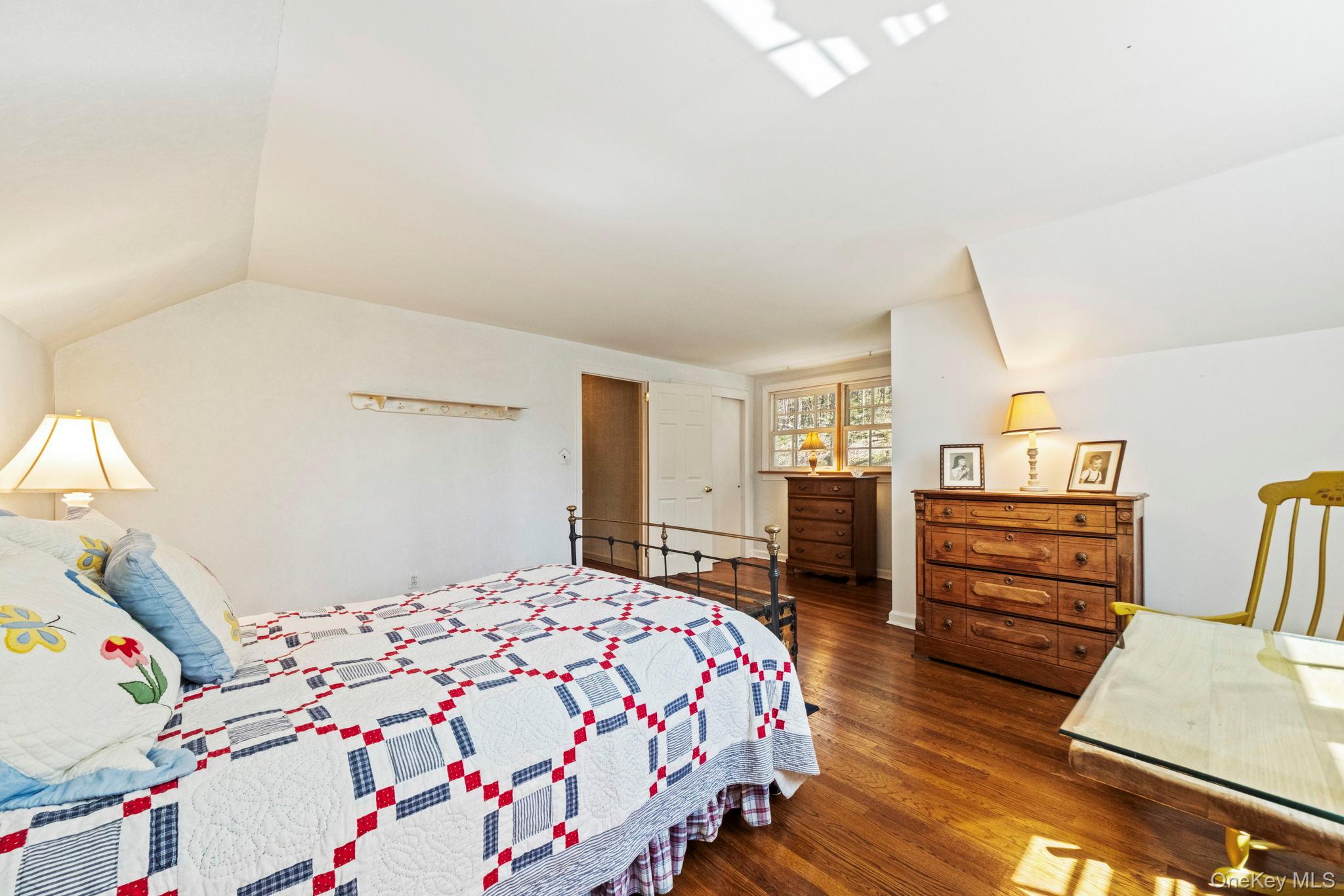 12 Harris Road Katonah, NY 10536 - Photo 24 of 38 a bedroom with a bed and wooden floor