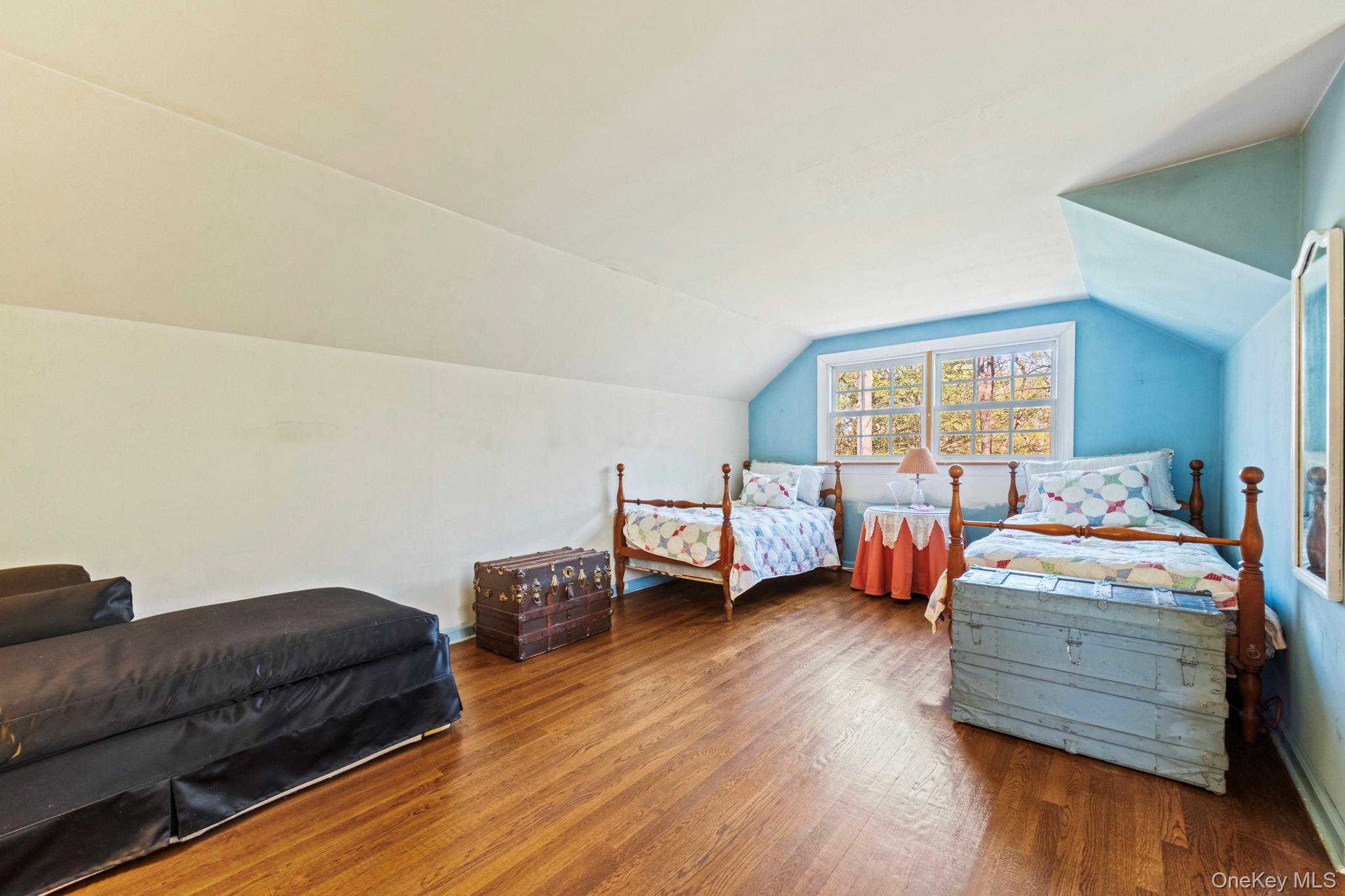 12 Harris Road Katonah, NY 10536 - Photo 25 of 38 a bedroom with furniture and a wooden floor