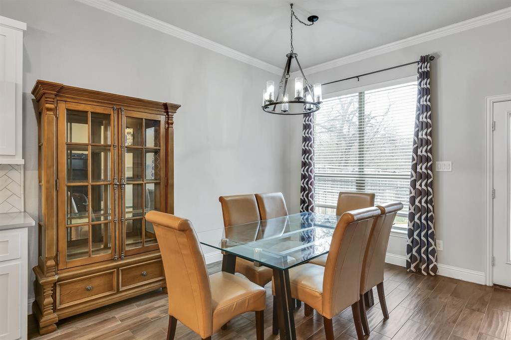 1306 Elizabeth Street Anna, TX 75409 - Photo 24 of 36 Dining area featuring wood tiled floors, crown molding, and a chandelier