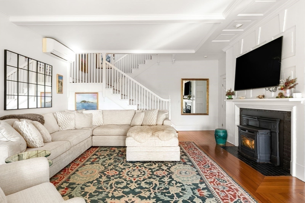 468 Summer Street Manchester, MA 01944 - Photo 17 of 36 a living room with furniture a flat screen tv and a fireplace