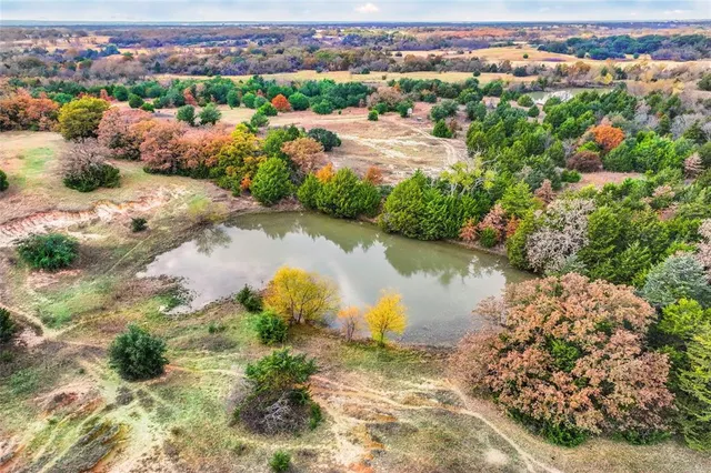 an aerial view of residential houses with outdoor space and river