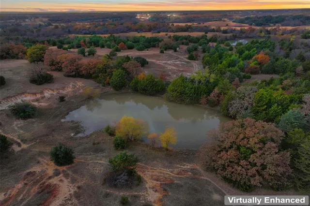 an aerial view of mountains residential house and green space