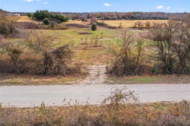 a view of a field with an ocean