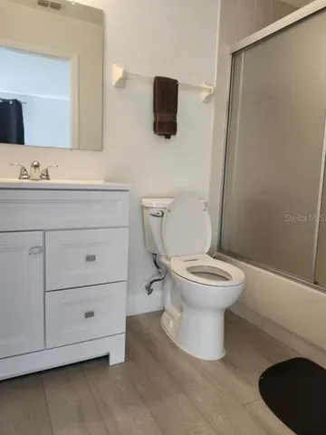 a bathroom with a toilet a sink and a mirror