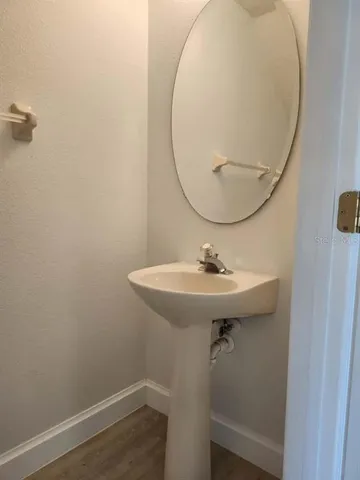 a bathroom with a sink a mirror and a toilet