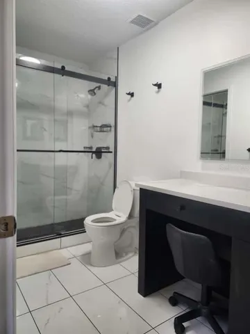a bathroom with a toilet a sink and shower