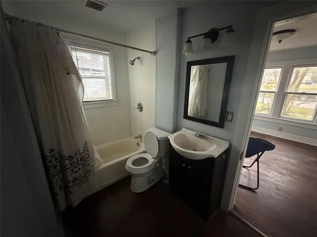 a bathroom with a sink a toilet and mirror