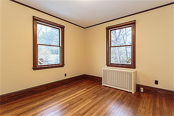 59 Coolidge Road Arlington, MA 02476 - Photo 14 of 22 a view of an empty room with window and wooden floor