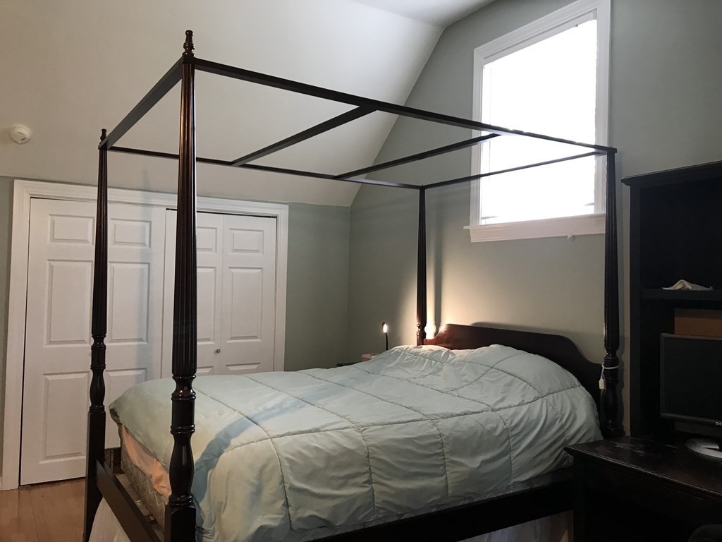 6 Braemore Road Natick, MA 01760 - Photo 16 of 27 a bedroom with a bed and a flat screen tv