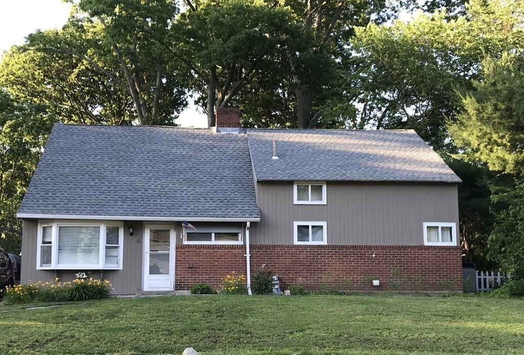 6 Braemore Road Natick, MA 01760 - Photo 27 of 27 a front view of a house with a garden and yard