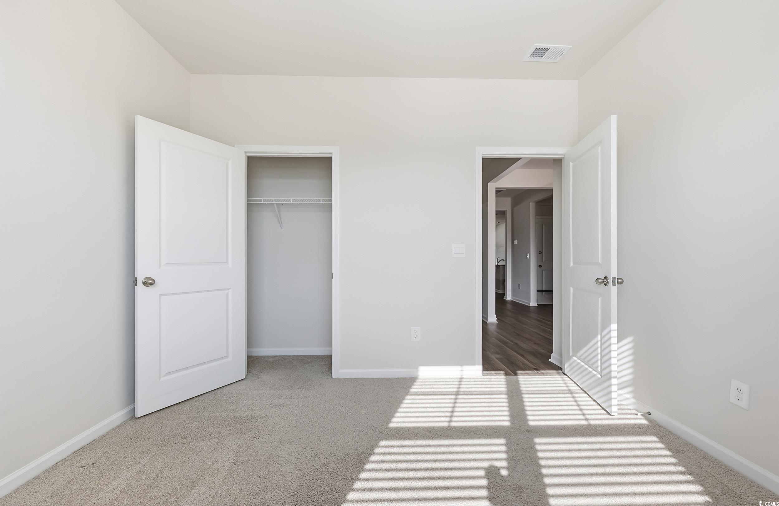 270 Columbus Street Conway, SC 29526 - Photo 16 of 38 Unfurnished bedroom featuring light carpet and a closet