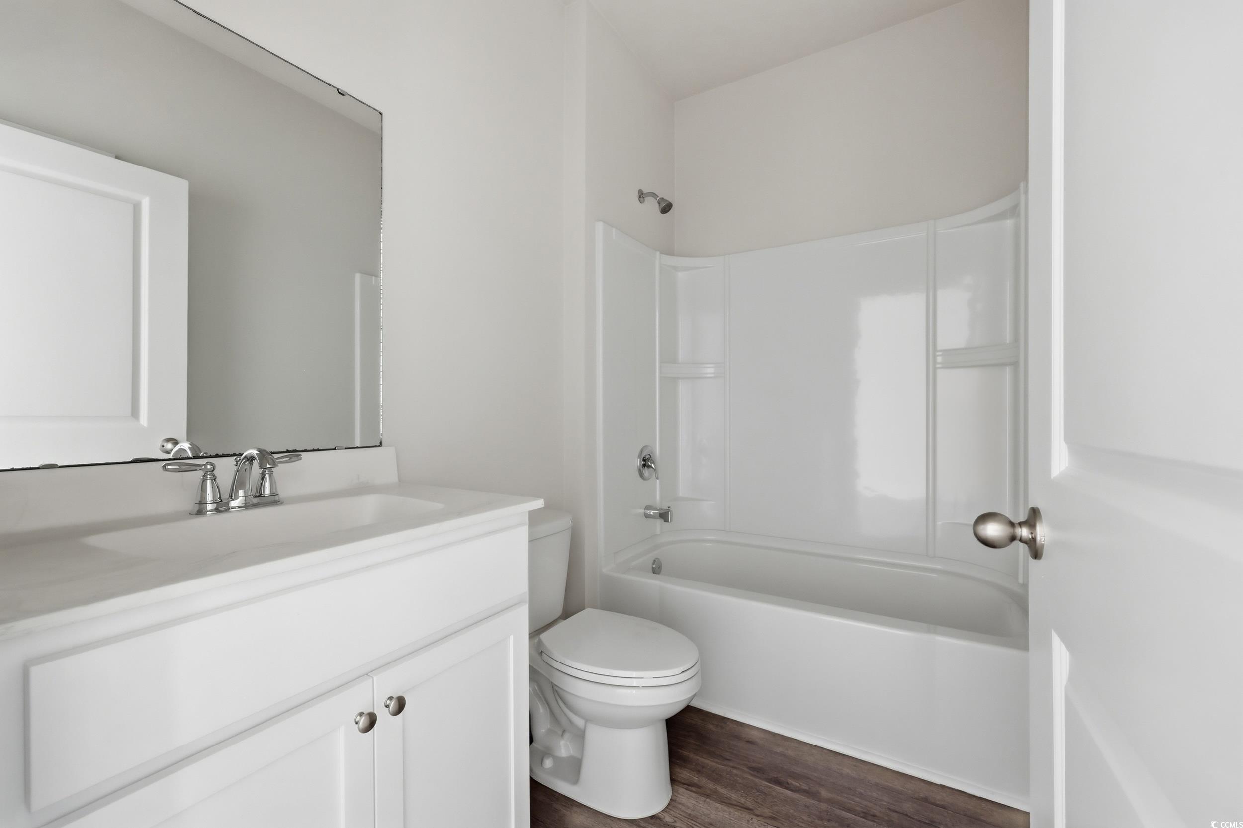 270 Columbus Street Conway, SC 29526 - Photo 17 of 38 Full bathroom with vanity, tub / shower combination, and dark wood-style floors