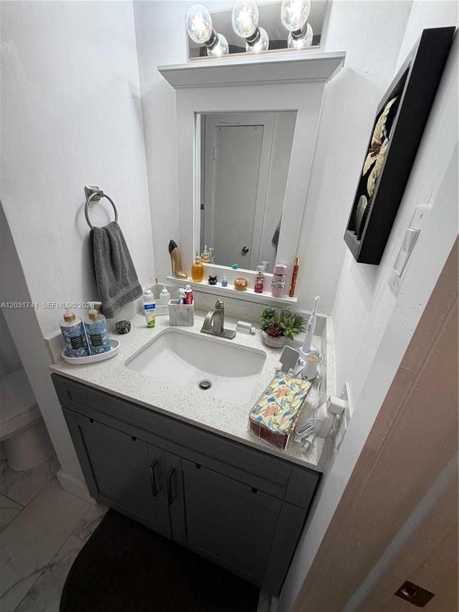 3500 Harrison Street, Unit 4 Hollywood, FL 33021 - Photo 9 of 10 a bathroom with a sink and a mirror