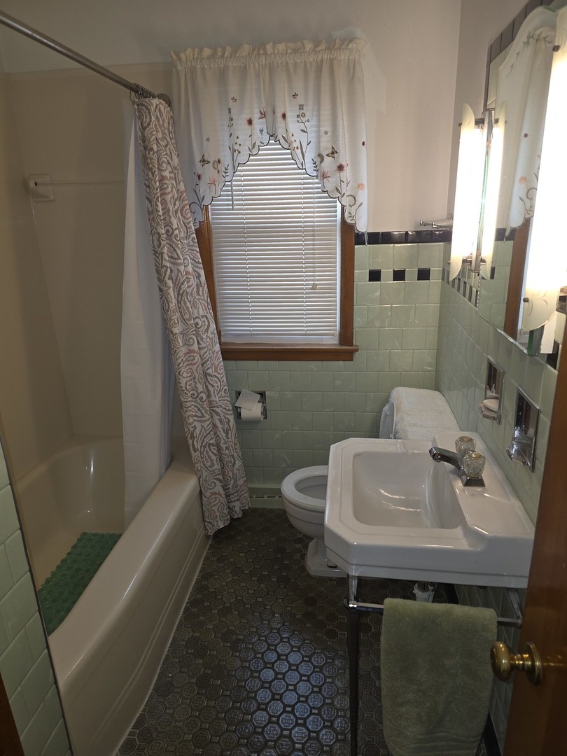 3522 Washington Street Lansing, IL 60438 - Photo 6 of 12 a bathroom with a sink a toilet and shower