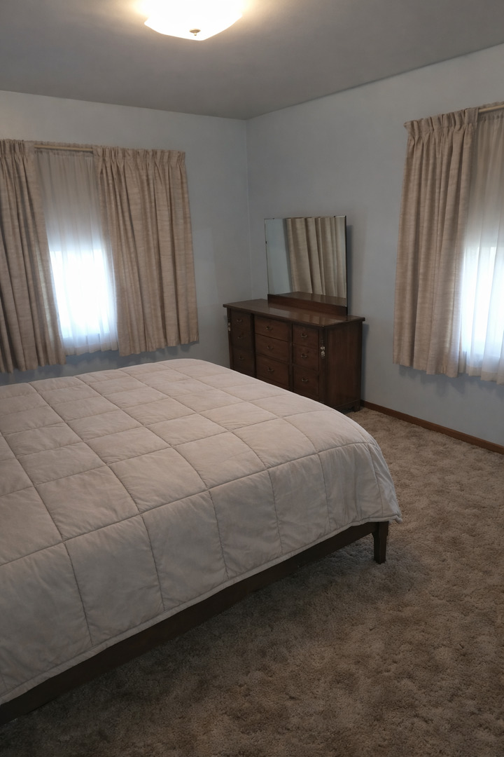 3522 Washington Street Lansing, IL 60438 - Photo 7 of 12 a spacious bedroom with a bed and a window