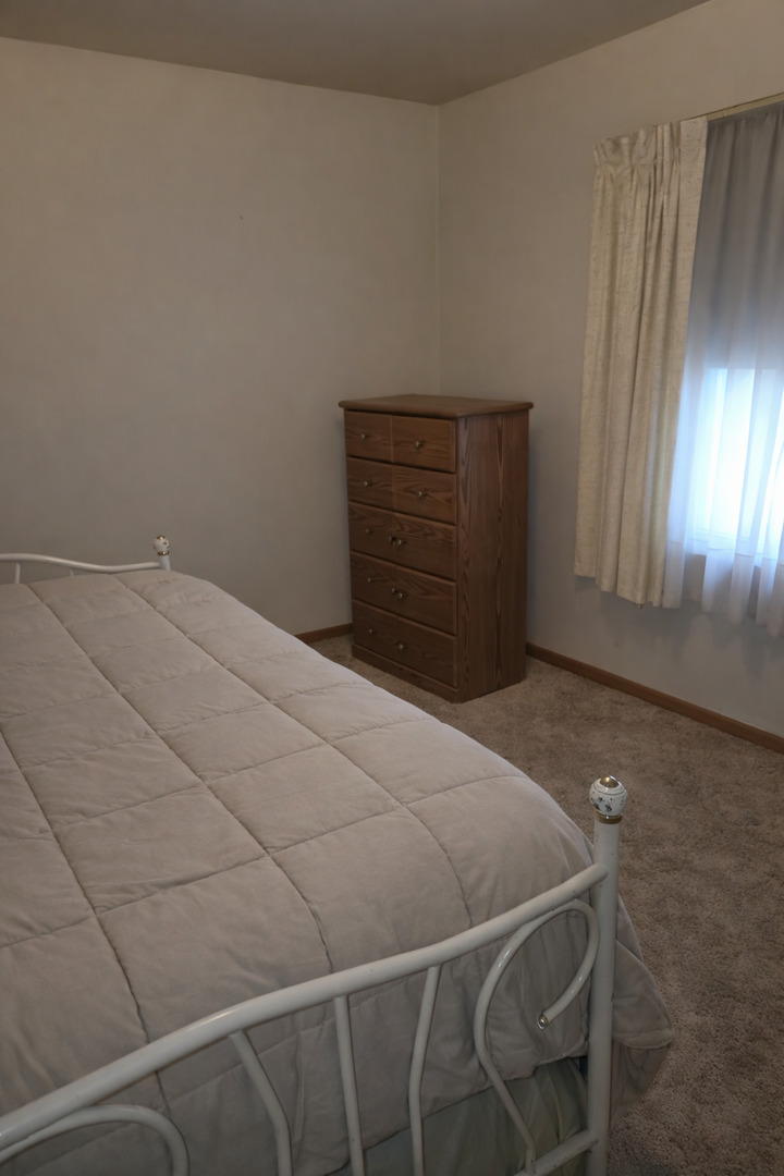 3522 Washington Street Lansing, IL 60438 - Photo 8 of 12 a bedroom with a bed and a mirror